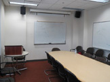 Long table, white boards, podium.