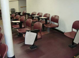 Rows of chairs with built-in desks.