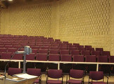 Overhead projector and auditorium seating.
