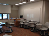 Picture of the side of the room with a large white board to the right of the instructor's desk.