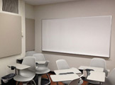 Picture of the side of the room with a whiteboard and wall
