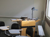 Photo of Locy Hall room number 110 showing teachers' desk