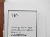 Photo of Locy Hall room number 110 label outside the room