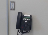 Wall-mounted telephone.