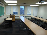 View of classroom seating, blackboard, and podium.
