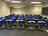 student chairs and blackboard