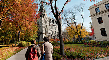 Students walking on campus in the fall
