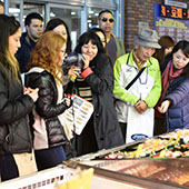 people in front of food stand in Japan