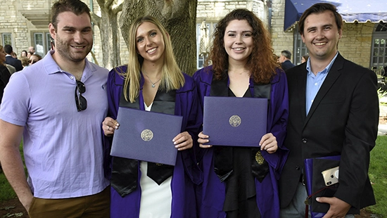 graduate students holding diplomas