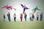 Dassia Posner, center, in red, and her Puppetry History and Performance students fly their pterodactyl puppets for their final projects. Posner is an assistant professor of theater as well as of Slavic languages and literature. Photo by Kerry Trotter.