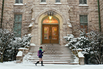 A student braves the snow outside University Hall. 