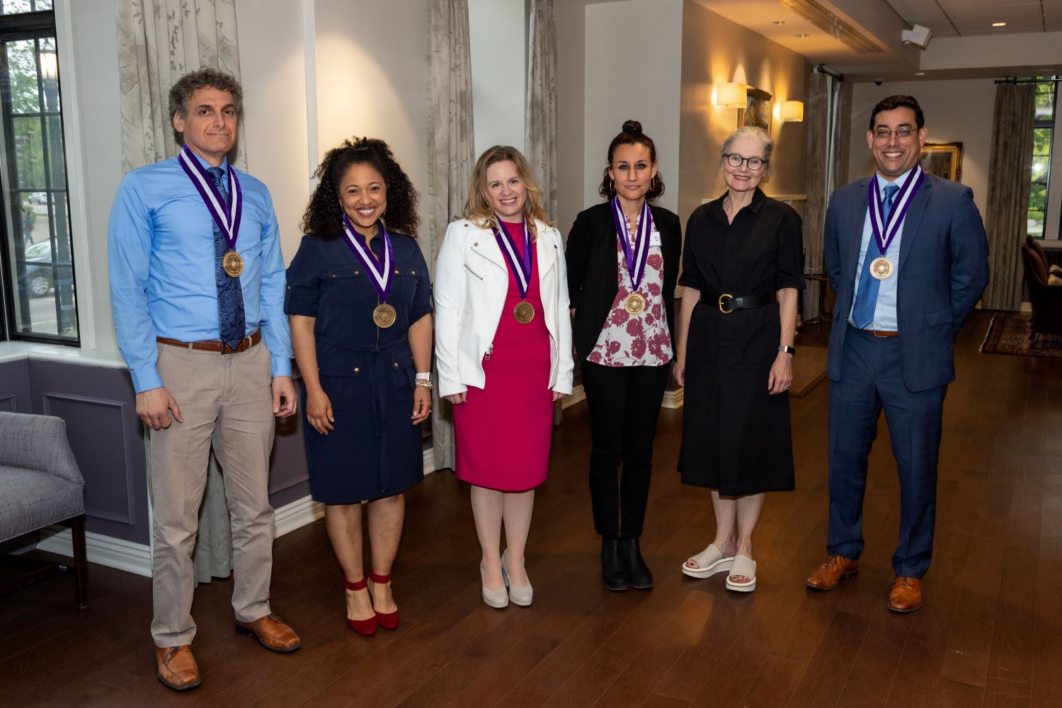 Five 2022 Teaching Awards winners pose with Provost Kathleen Hagerty while wearing their medals.