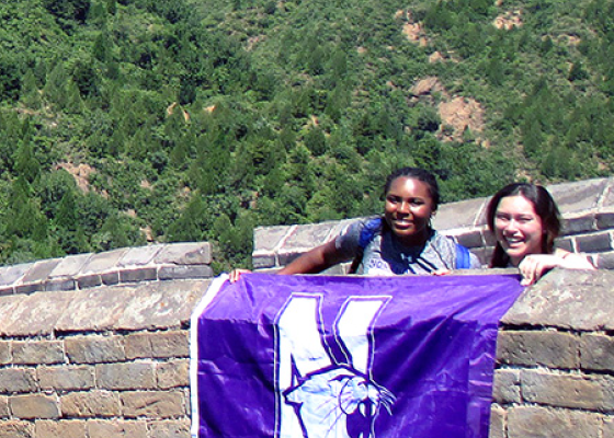 students on a field trip holding Northwestern flag