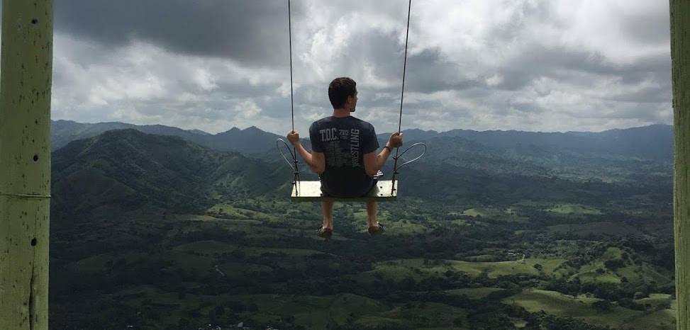 Student on a mountaintop swing in the Dominican Republic