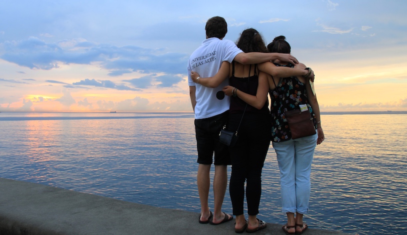 Three friends overlooking the water