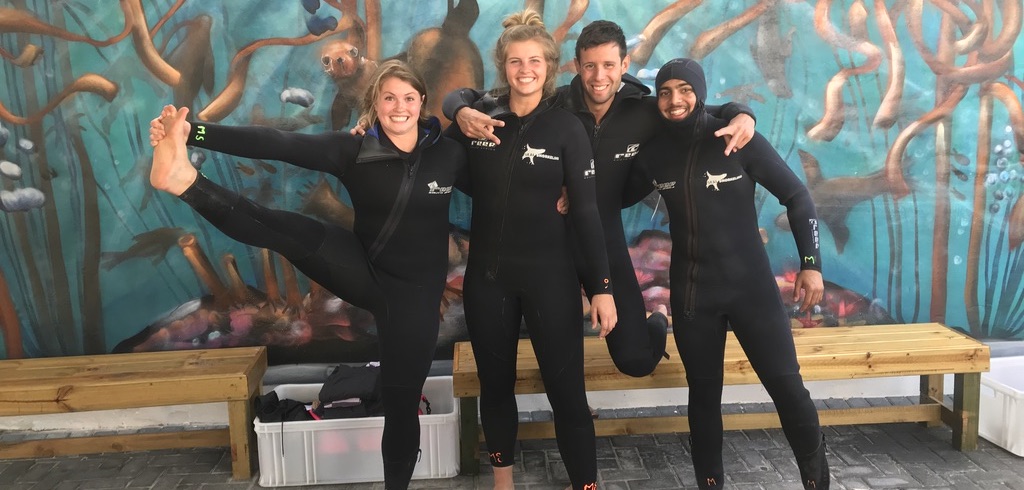 Student and friends in wetsuits, ready to explore the ocean