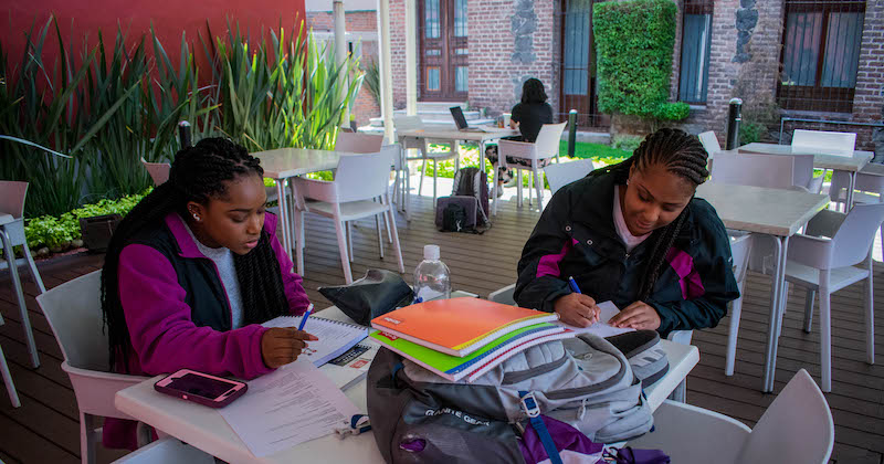 Students studying at an outdoor table in Mexico City, Mexico