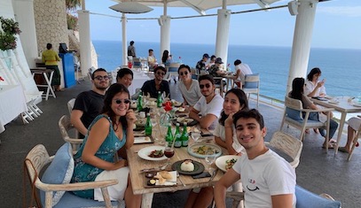 students at lunch by the ocean