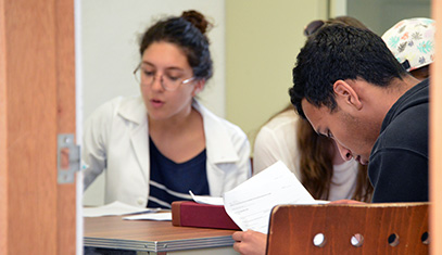 Students reading health and safety resources