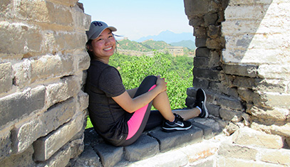 Girl sitting on a stone arch