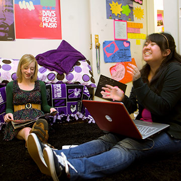 students laughing in dorm room