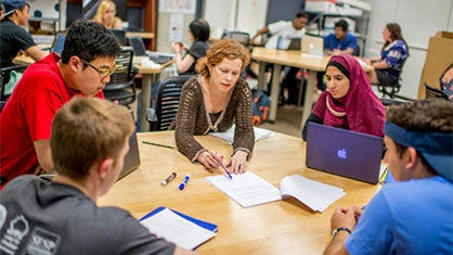 students sitting around table with instructor