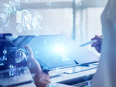 Person using a stylus on a glowing tablet with digital data overlays.
