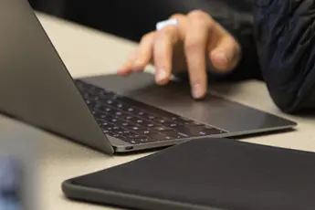 hands typing on a laptop