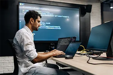 male student working on a laptop