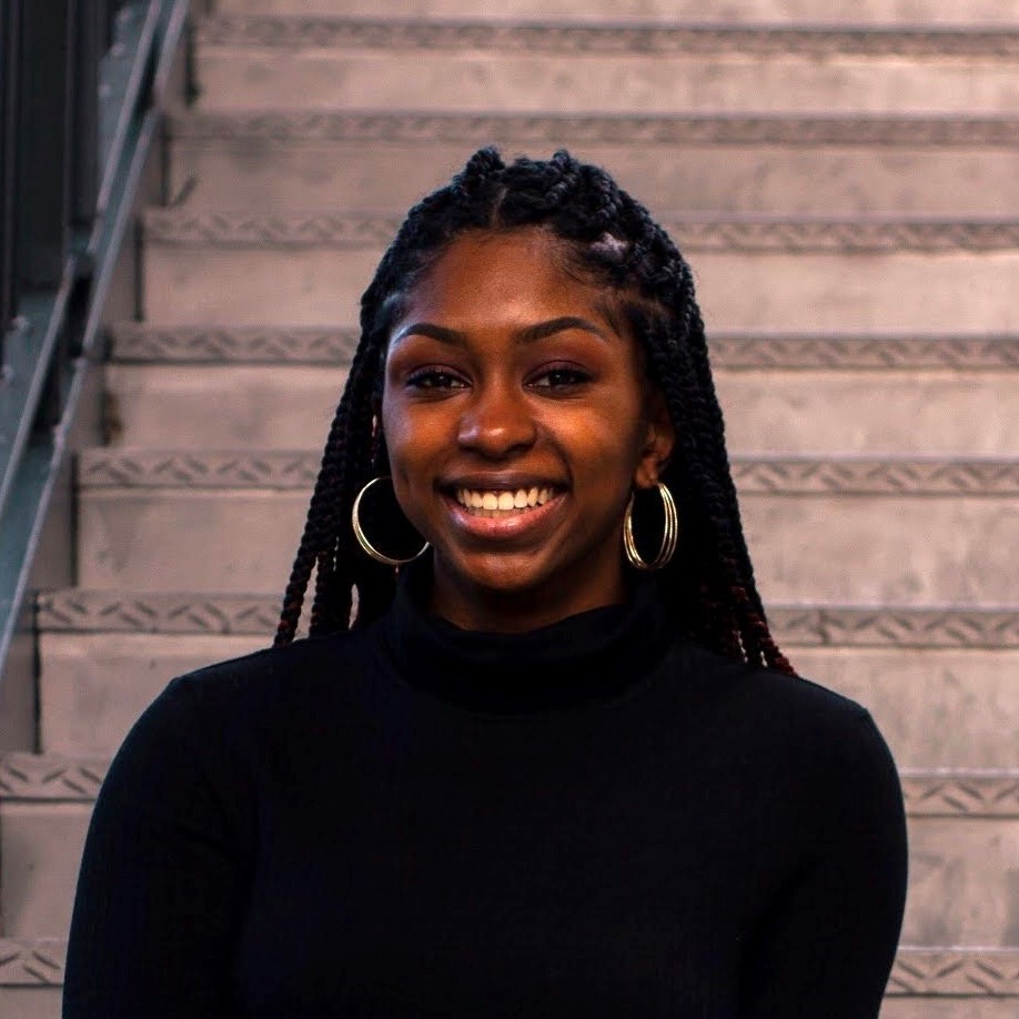 Courtlyn Brown wearing a black sweater smiling at the camera