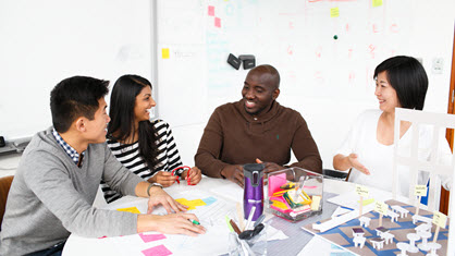 Image of four students sitting around a table