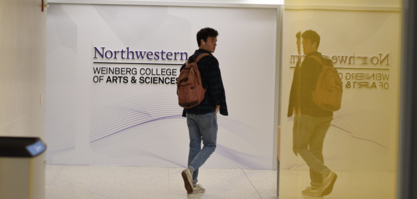 student walking next to the environmental graphic