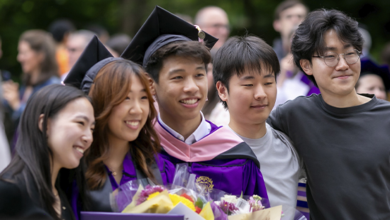 Northwestern graduates holding flowers