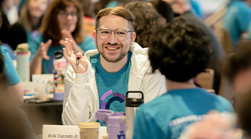 CatalystNU participant smiling talking with another person