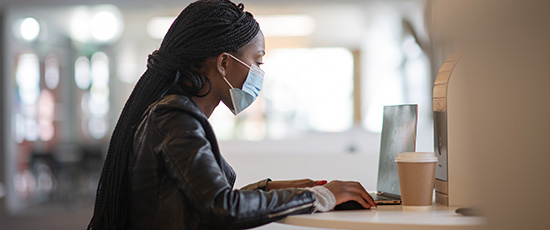 student on campus wearing mask