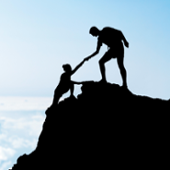 helping someone climb a mountain