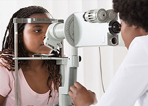 Ophthalmologist examines child's eyes.