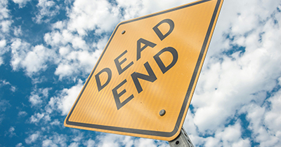 A photo of a yellow dead end traffic sign