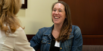 Photo of woman engaged in conversation with a smile on her face