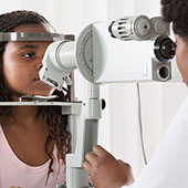 Ophthalmologist examines child's eyes