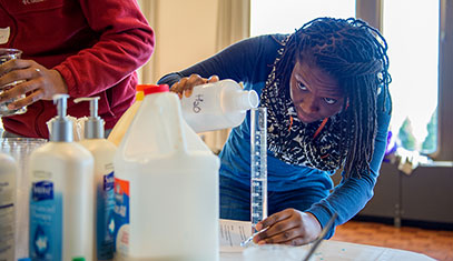 students pouring liquids in test tubes