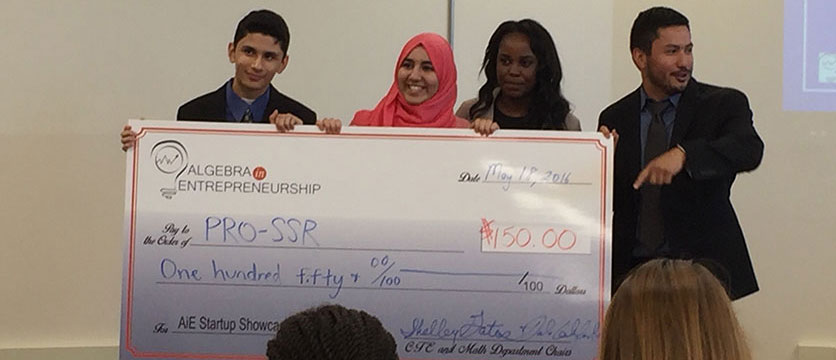 Image of students holding a big check.