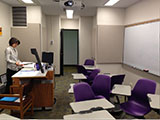 View of classroom with instructor at podium.