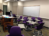 View of whiteboard, chairs.