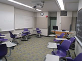 Classroom scene, including chairs with built-in desks.