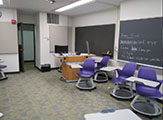 Classroom sign, including chairs with built-in desks.