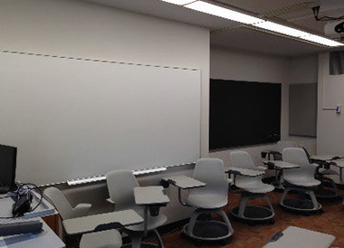 Side view of the room with chairs, white board and chalk board