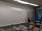 Picture of chairs and classroom and whiteboard on wall