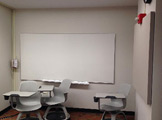 Picture of a white board and chairs