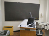 Picture of the chalk board and instructor's podium